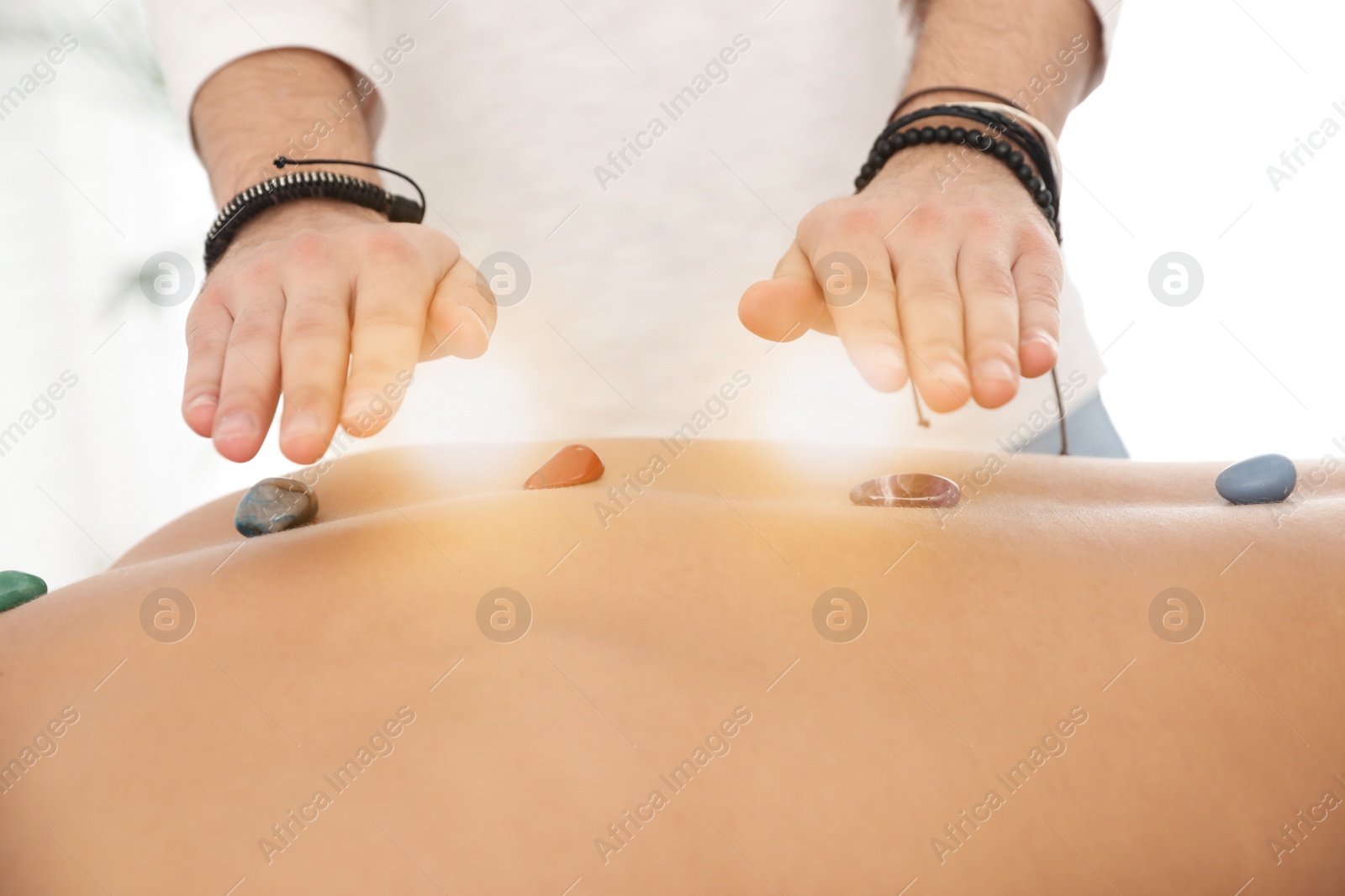 Photo of Man during crystal healing session in therapy room, closeup