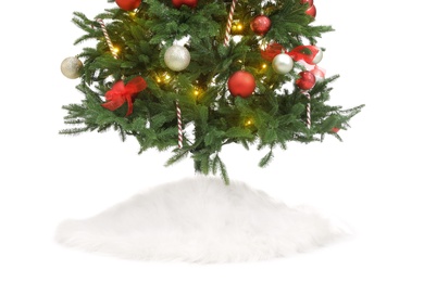 Photo of Beautiful decorated Christmas tree with skirt on white background