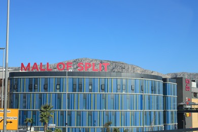 View of modern shopping mall in city under blue sky