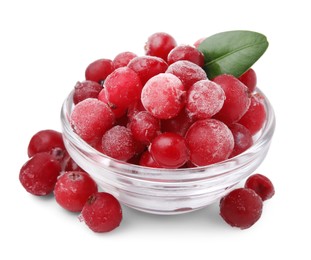 Photo of Frozen red cranberries in bowl and green leaf isolated on white