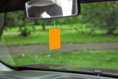 Photo of Air freshener hanging in car against windshield