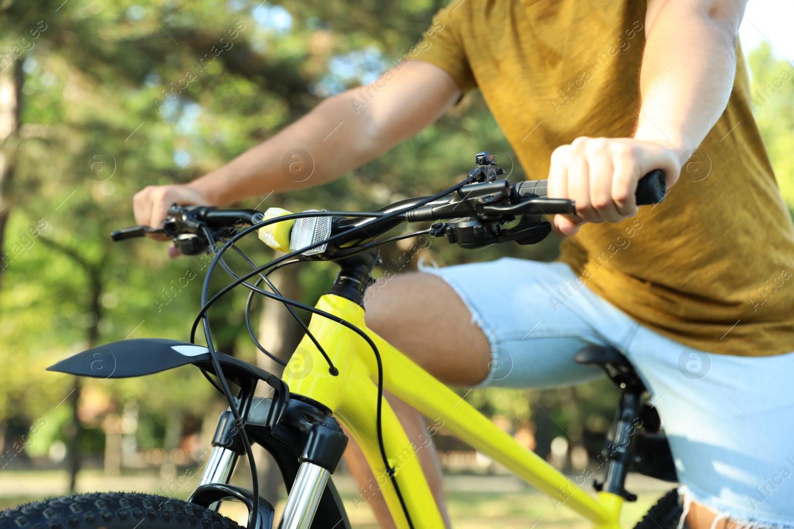 Photo of Young man with bicycle in city park, closeup