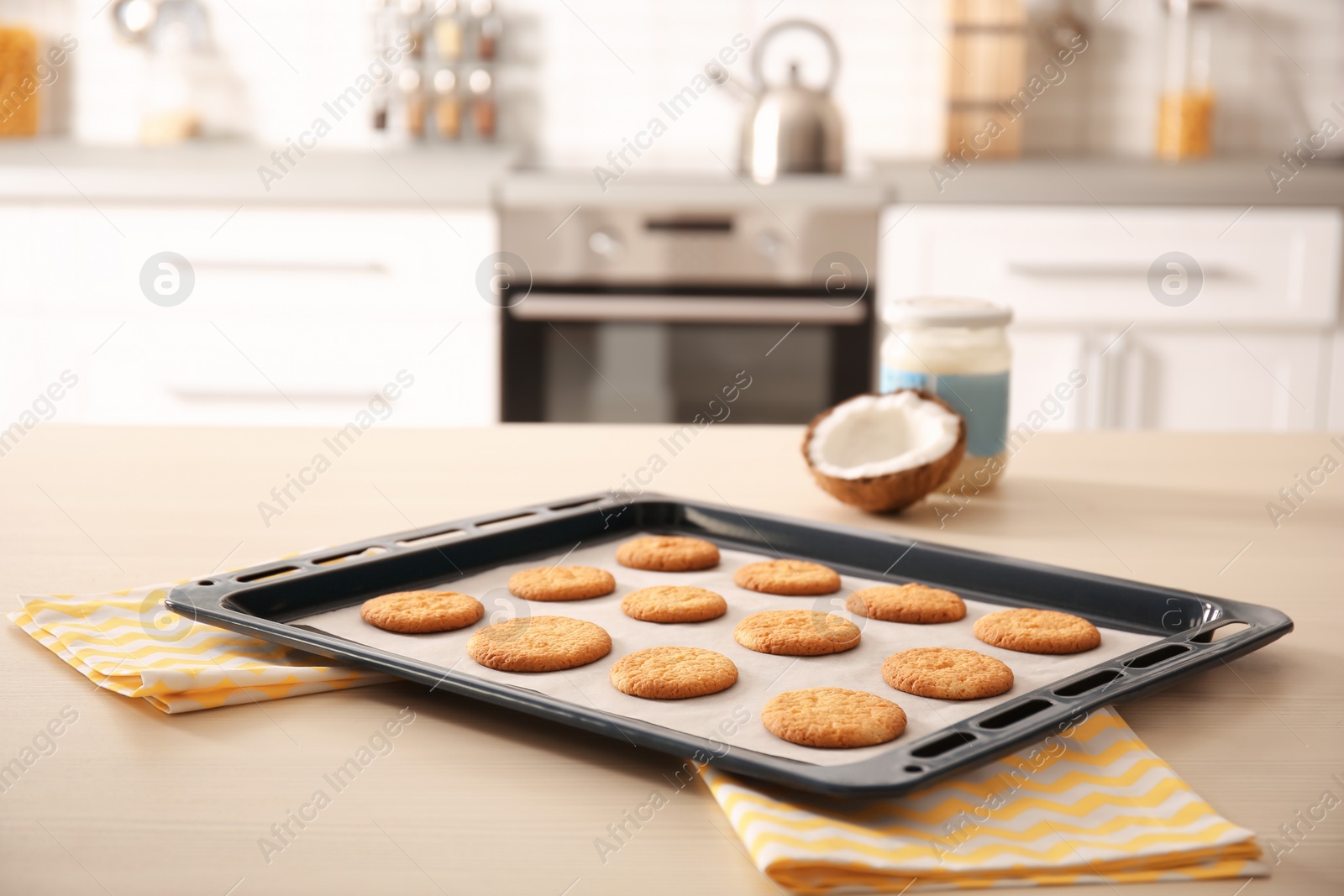 Photo of Baking tray with cookies and coconut on wooden table