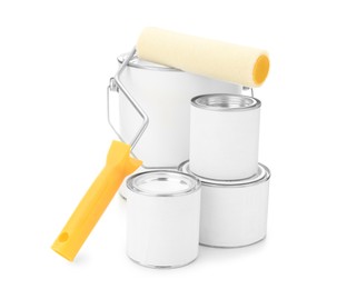 Photo of Closed blank cans of paint and roller brush on white background