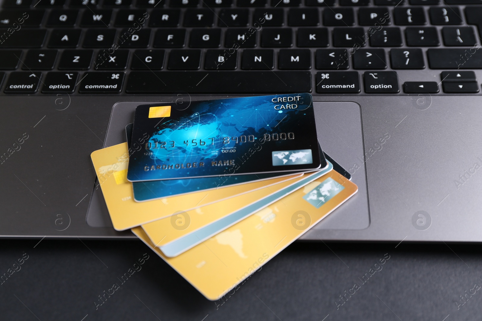 Photo of Laptop with credit cards on grey table