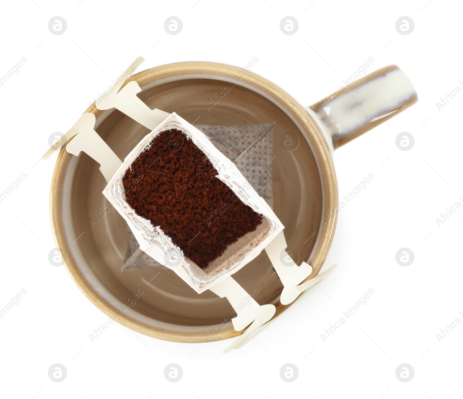 Photo of Cup with drip coffee bag isolated on white, top view