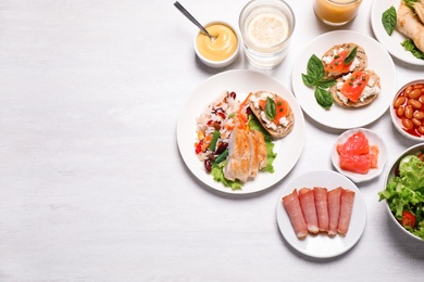 Buffet service. Flat lay composition with different dishes on white wooden table, space for text