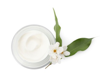 Photo of Glass jar of face cream, leaves and flowers on white background, top view