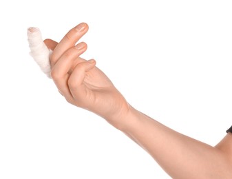 Woman with finger wrapped in medical bandage on white background, closeup