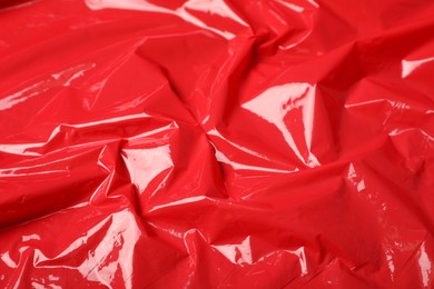 Photo of Red plastic stretch wrap as background, closeup