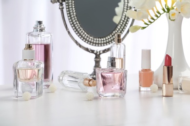 Photo of Perfume bottles on dressing table