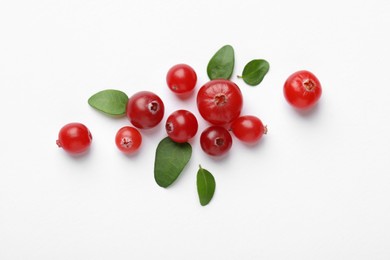 Photo of Fresh ripe cranberries and green leaves on white background, flat lay