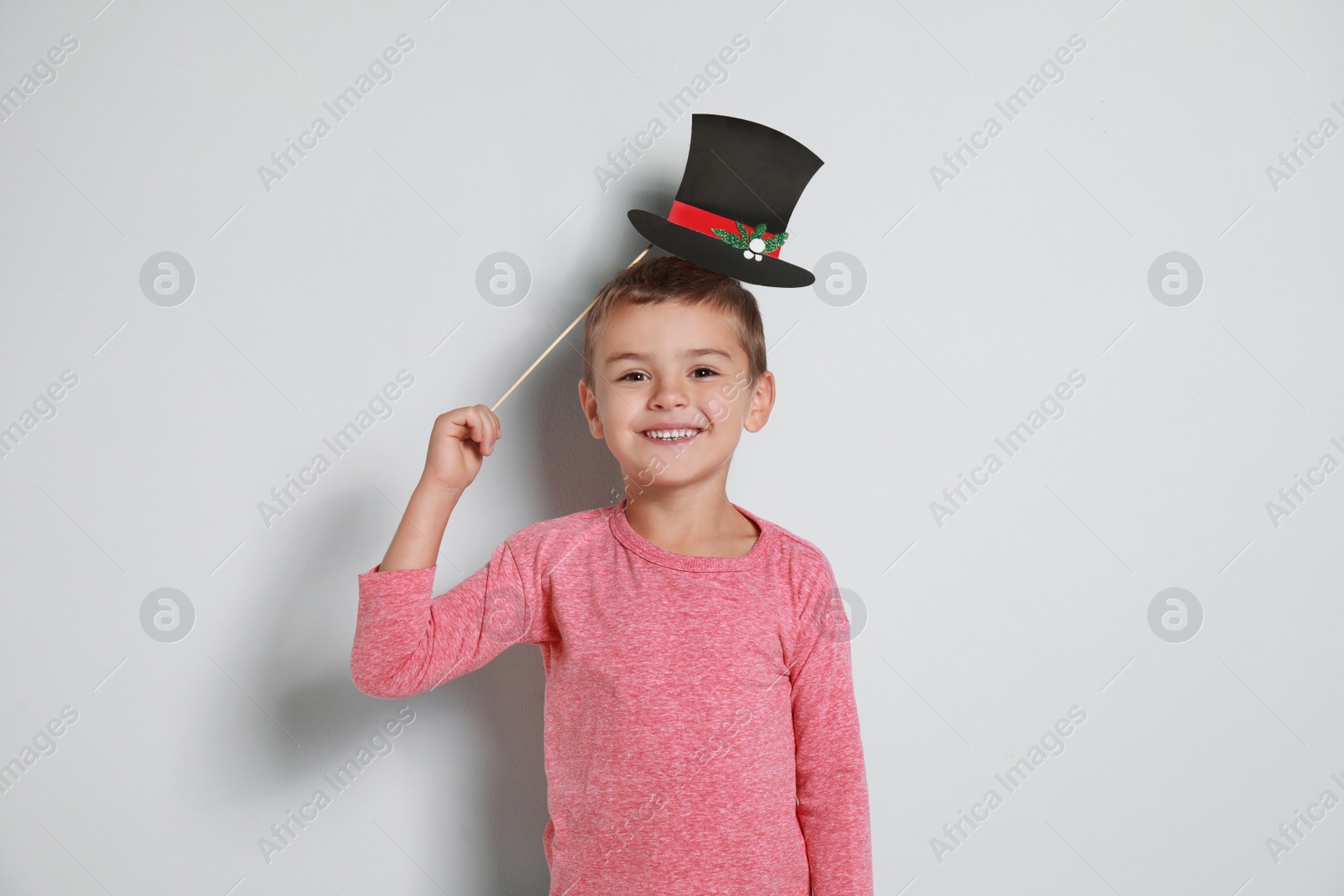 Image of Cute little boy with Christmas hat prop on white background