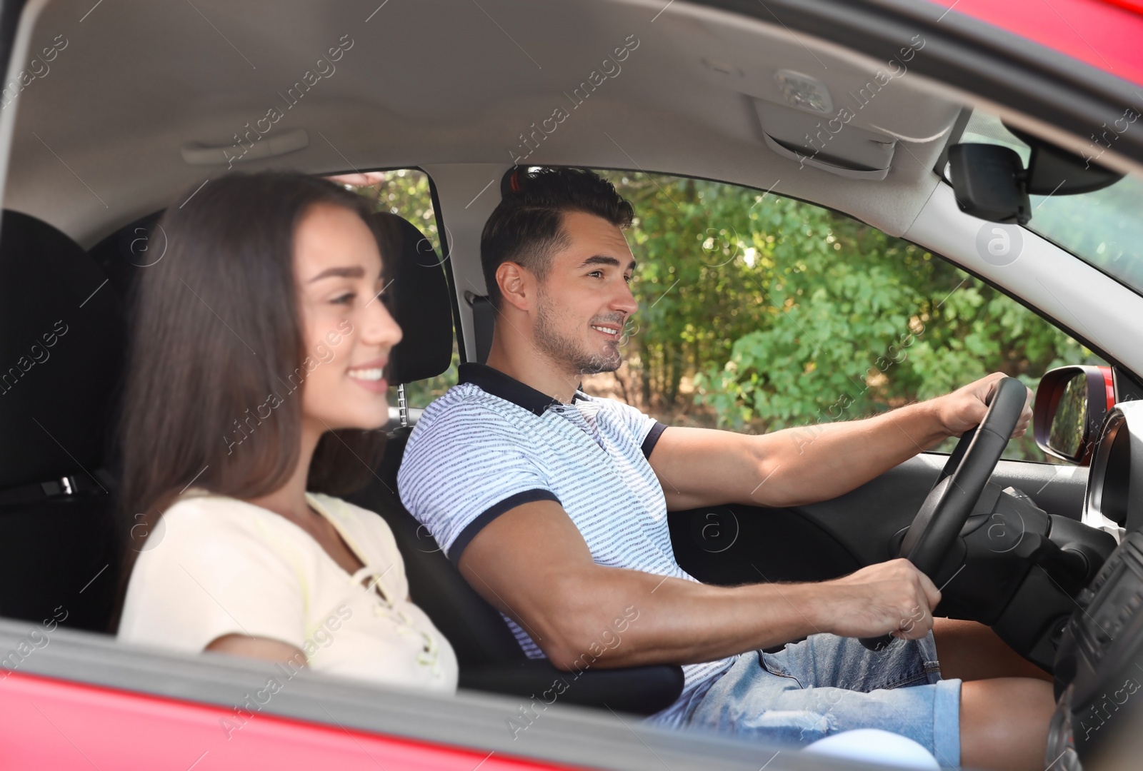 Photo of Happy young couple in car on road trip