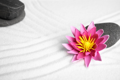 Photo of Zen garden. Beautiful lotus flower and stone on white sand