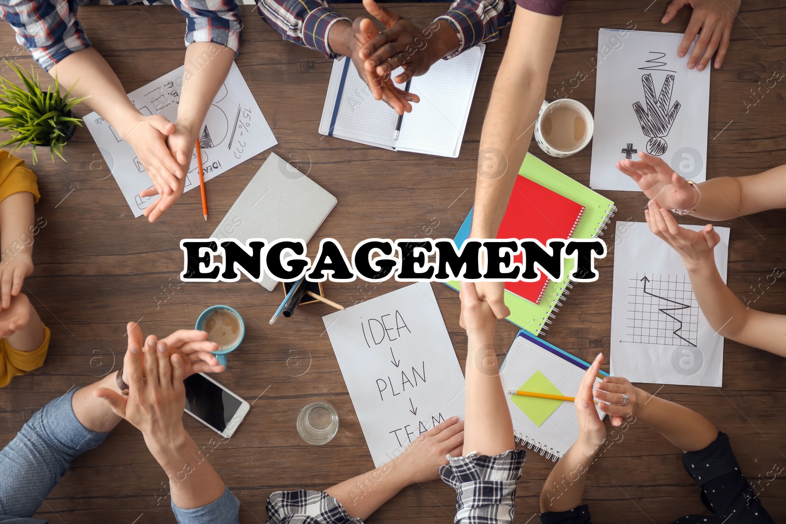 Image of Engagement concept. People working together at table, top view