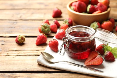 Photo of Delicious pickled strawberry jam and fresh berries on wooden table