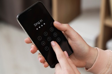 Photo of Woman unlocking smartphone with blocked screen indoors, closeup