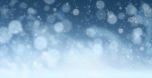 Image of Abstract snowfall on blue background, bokeh effect. Banner design 
