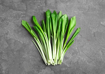 Fresh wild garlic or ramson on grey table, top view