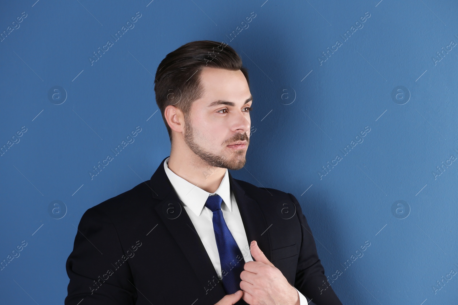 Photo of Portrait of young man with beautiful hair on color background