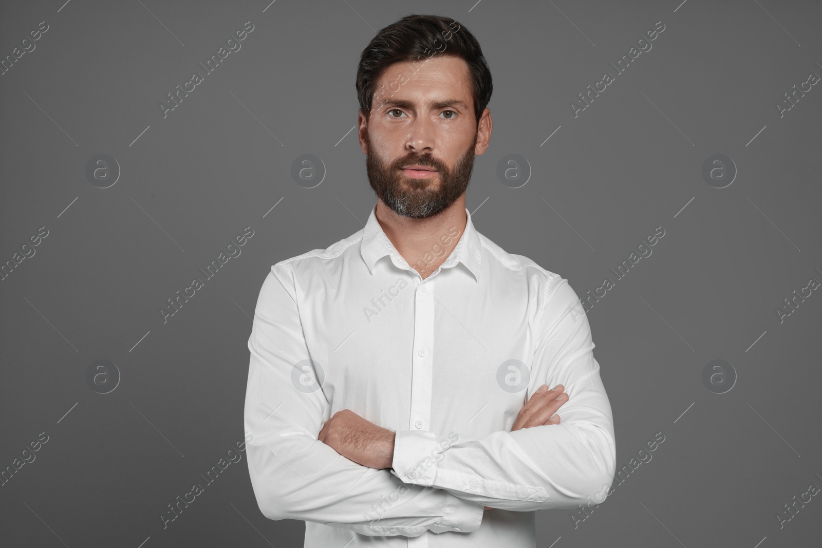 Photo of Portrait of handsome bearded man on grey background