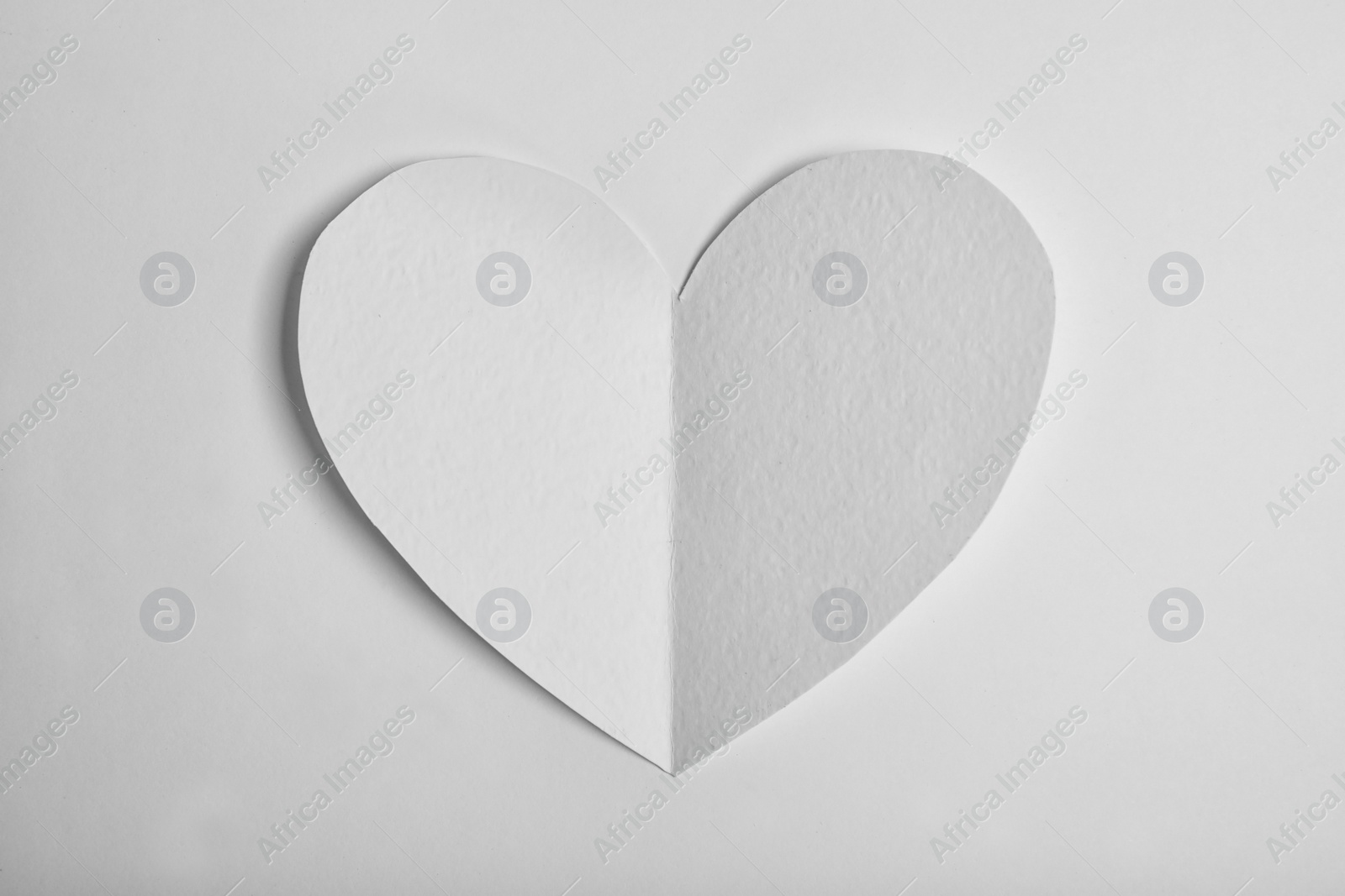 Photo of Paper heart on white background, top view