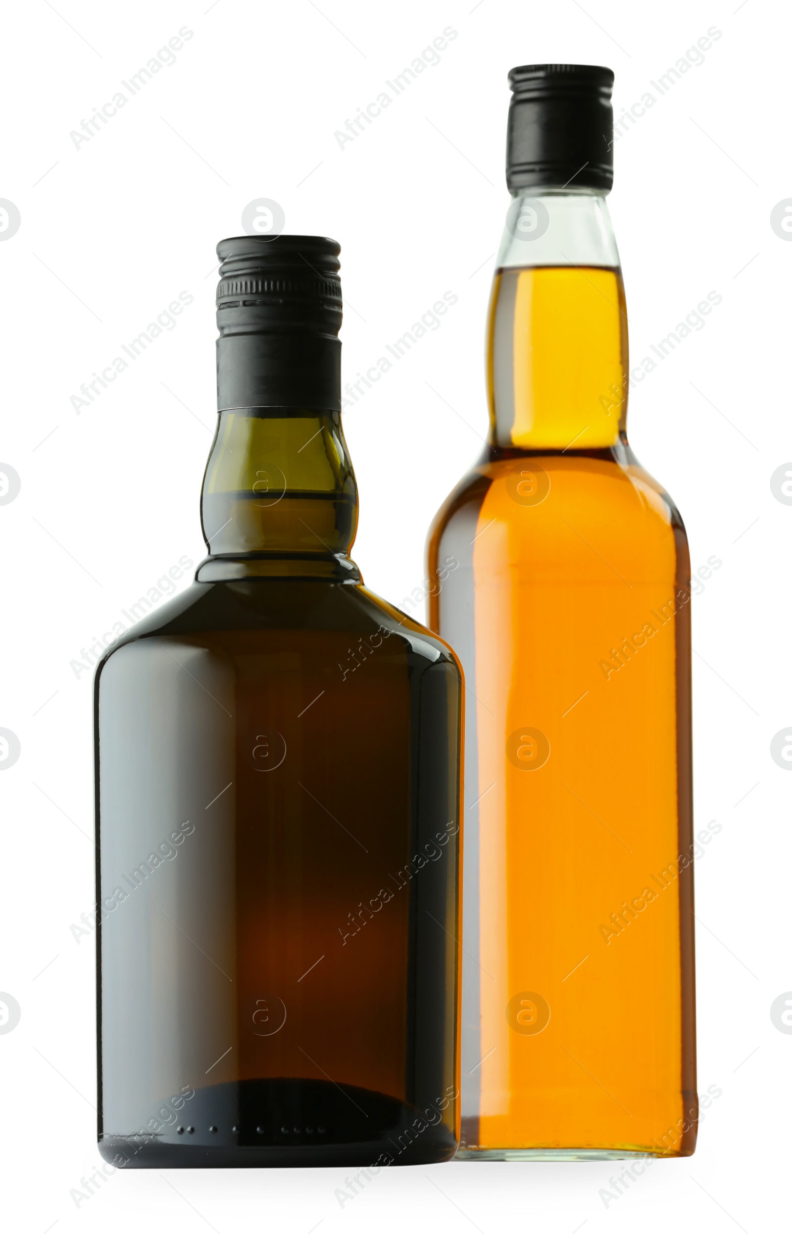 Photo of Different sorts of whiskey in glass bottles isolated on white