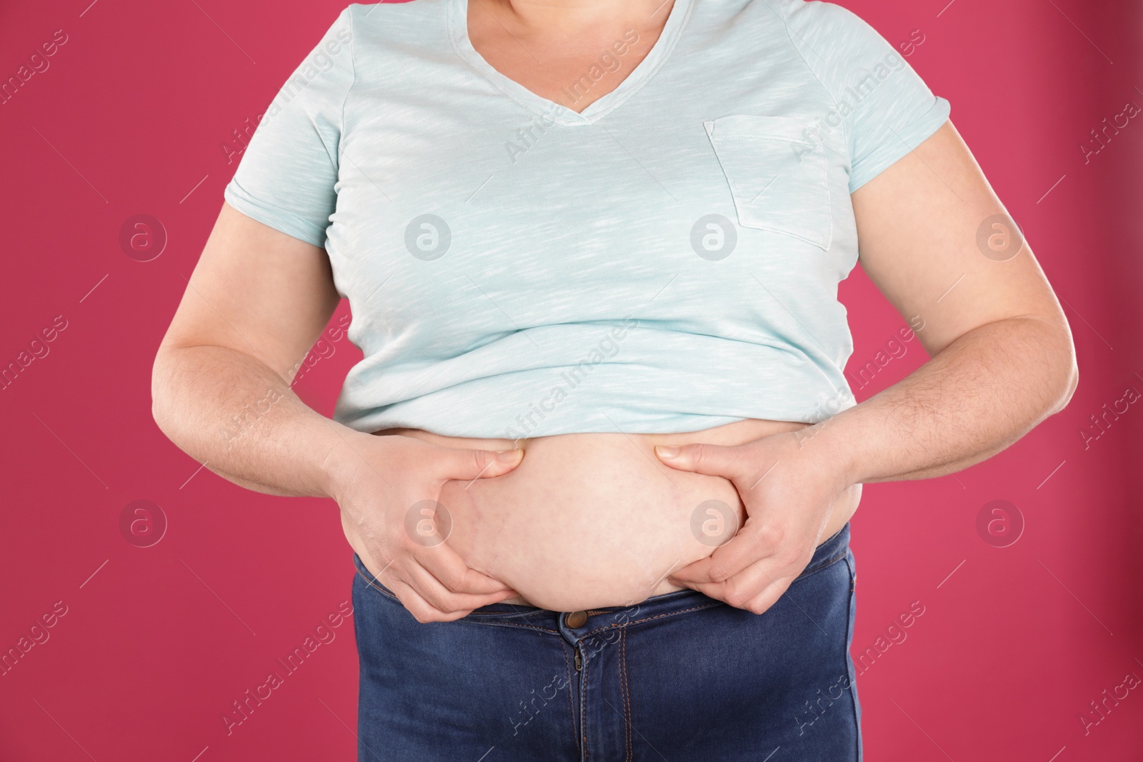 Photo of Overweight woman on color background, closeup. Obesity and weight loss