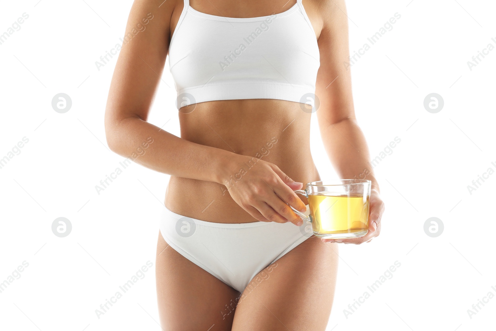 Photo of Young woman holding cup of diet tea on white background, closeup