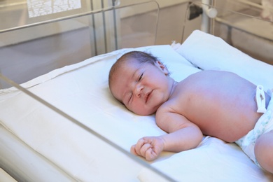 Photo of Newborn child under ultraviolet light in hospital