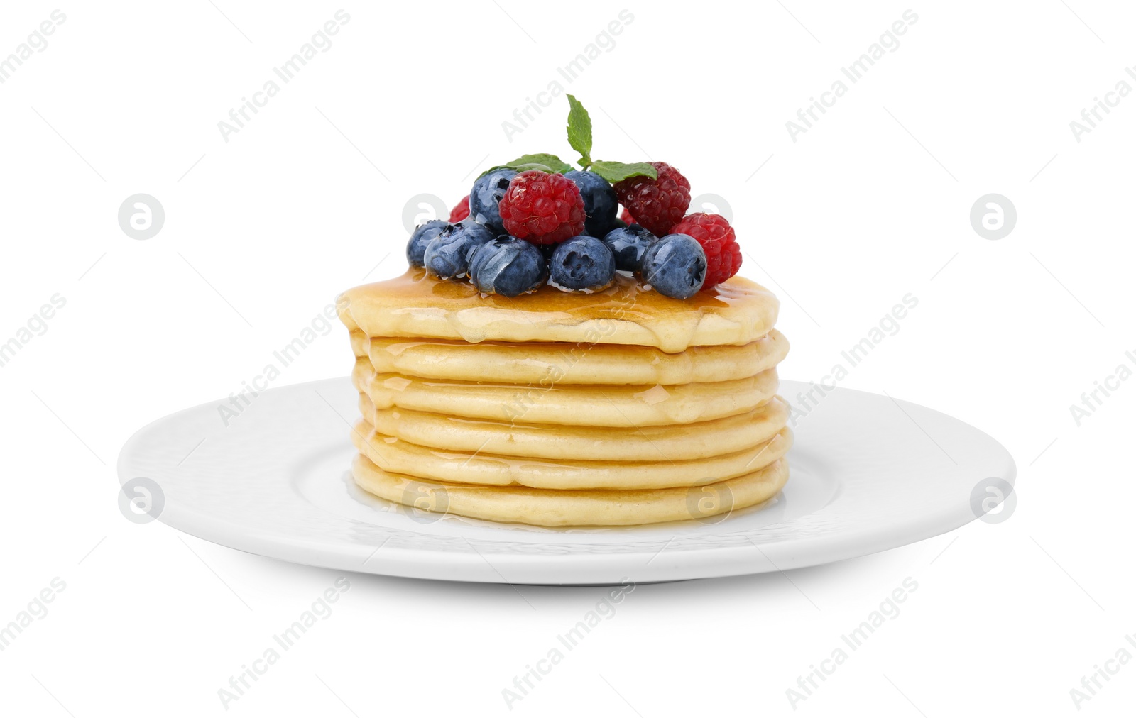 Photo of Delicious pancakes with berries, mint and honey isolated on white