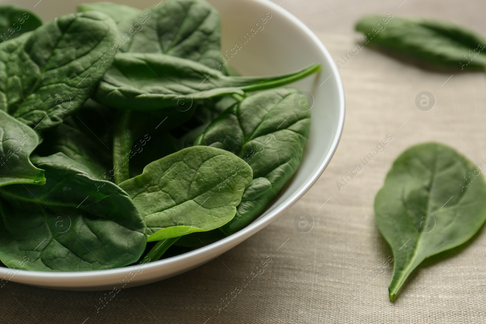 Photo of Fresh green healthy spinach leaves on wooden table, closeup