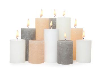 Photo of Many alight wax candles on white background