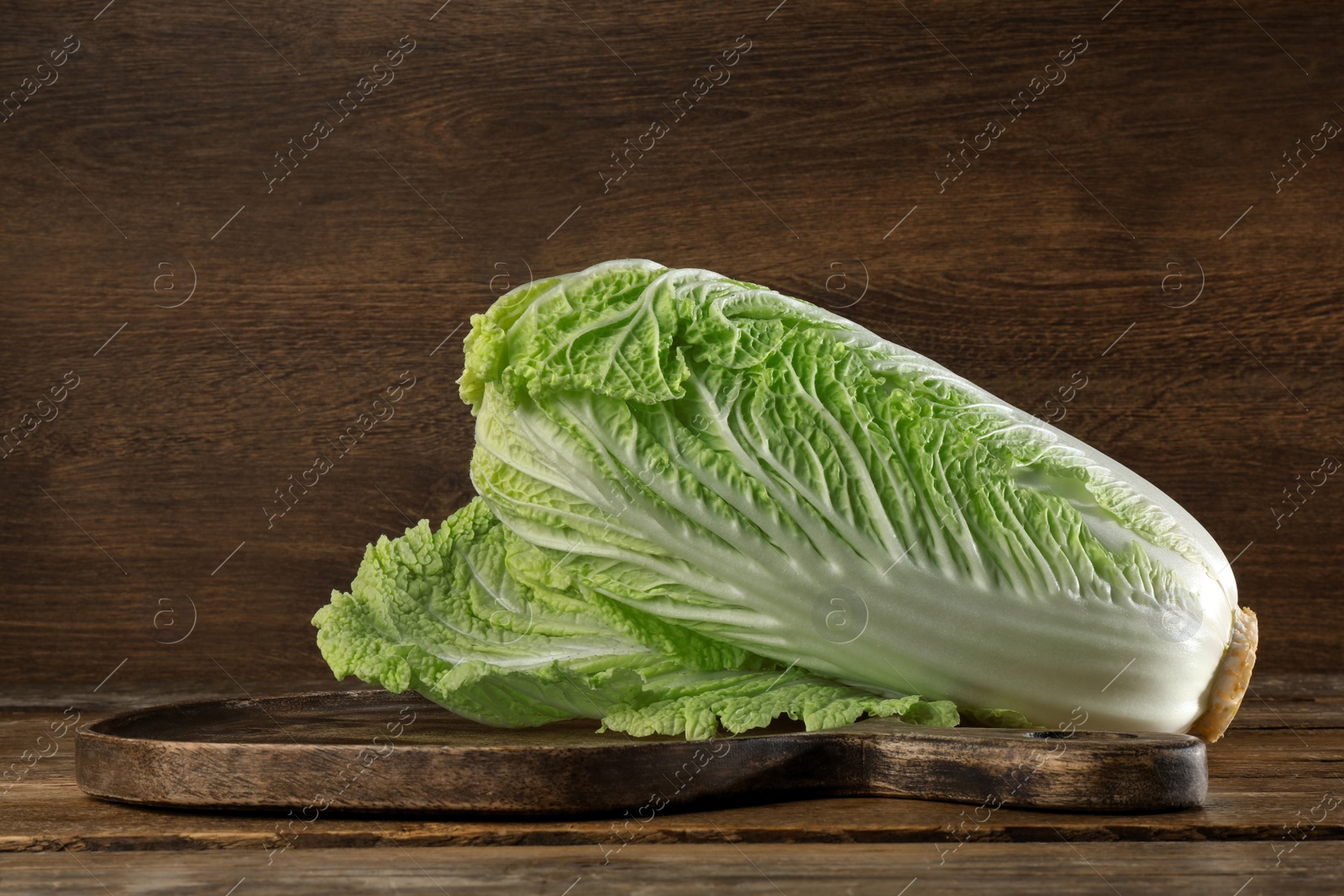 Photo of Fresh ripe Chinese cabbage on wooden table