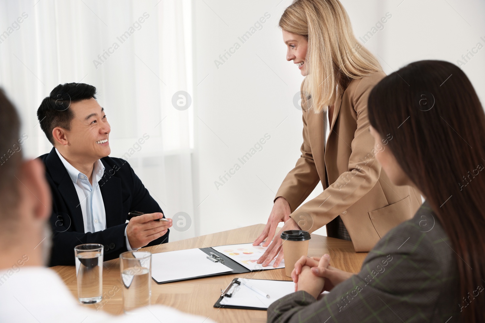 Photo of Businesswoman having meeting with her employees in office