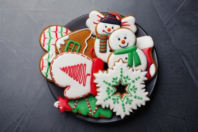 Photo of Delicious Christmas cookies on black table, top view