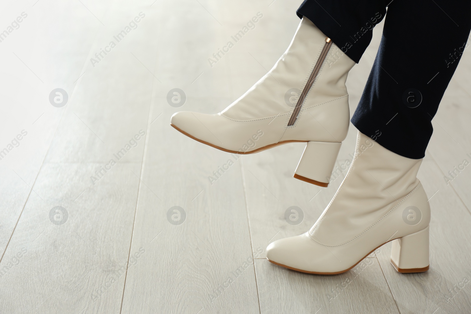 Photo of Woman wearing stylish leather shoes indoors, closeup. Space for text