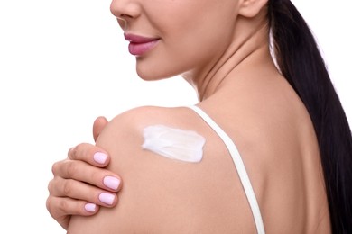 Woman with smear of body cream on her shoulder against white background, closeup