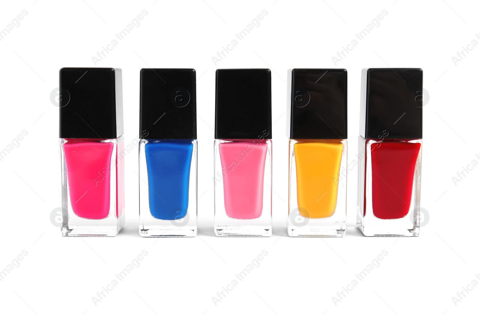 Photo of Bottles of nail polish on white background