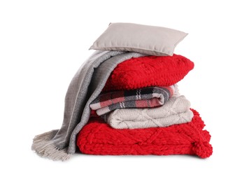 Photo of Stack of pillows and folded warm plaids on white background