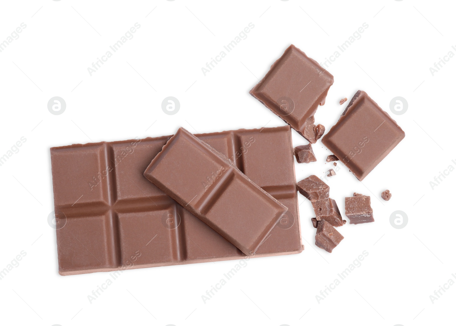 Photo of Pieces of delicious milk chocolate bar on white background, top view