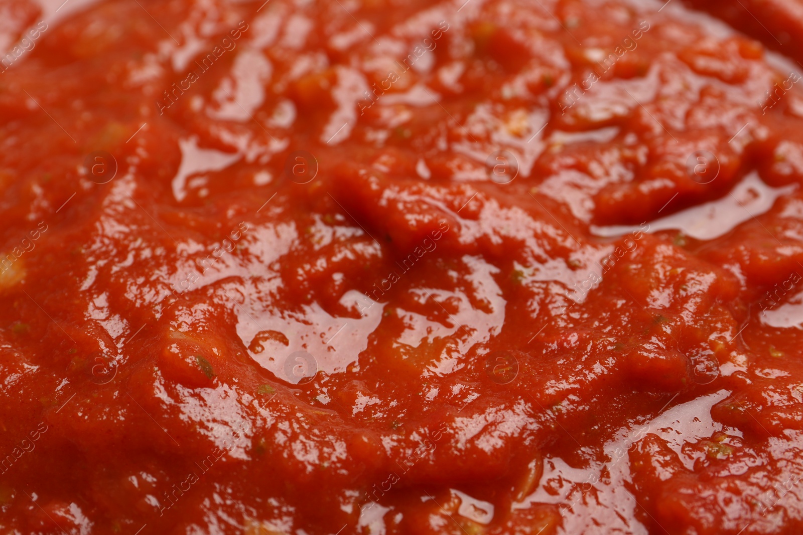 Photo of Texture of homemade tomato sauce as background, closeup