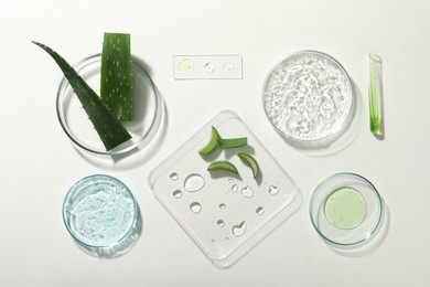 Photo of Flat lay composition with cosmetic gel, laboratory glassware and aloe on white background