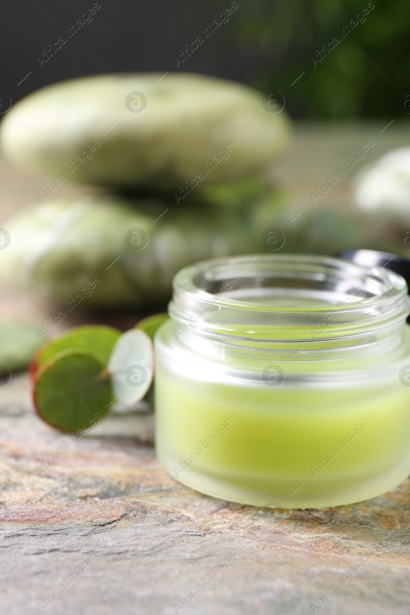 Photo of Jar of cream on textured table, closeup. Body care product