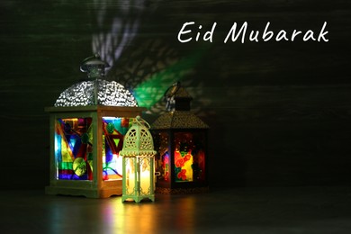 Image of Eid Mubarak greeting card. Arabic lanterns indoors at night