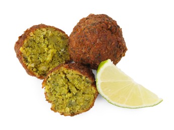 Photo of Delicious falafel balls and lime slice isolated on white, top view