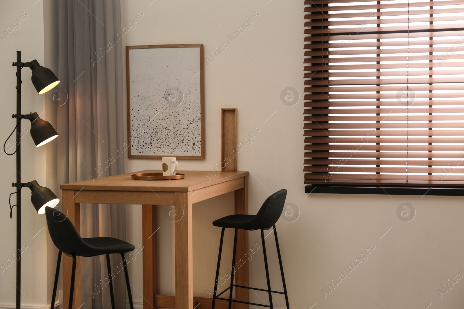 Photo of Modern room interior with table set, window blinds and stylish decor elements