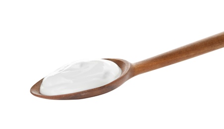 Photo of Spoon with creamy yogurt on white background