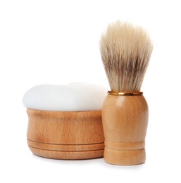 Photo of Shaving brush for men and bowl with foam on white background